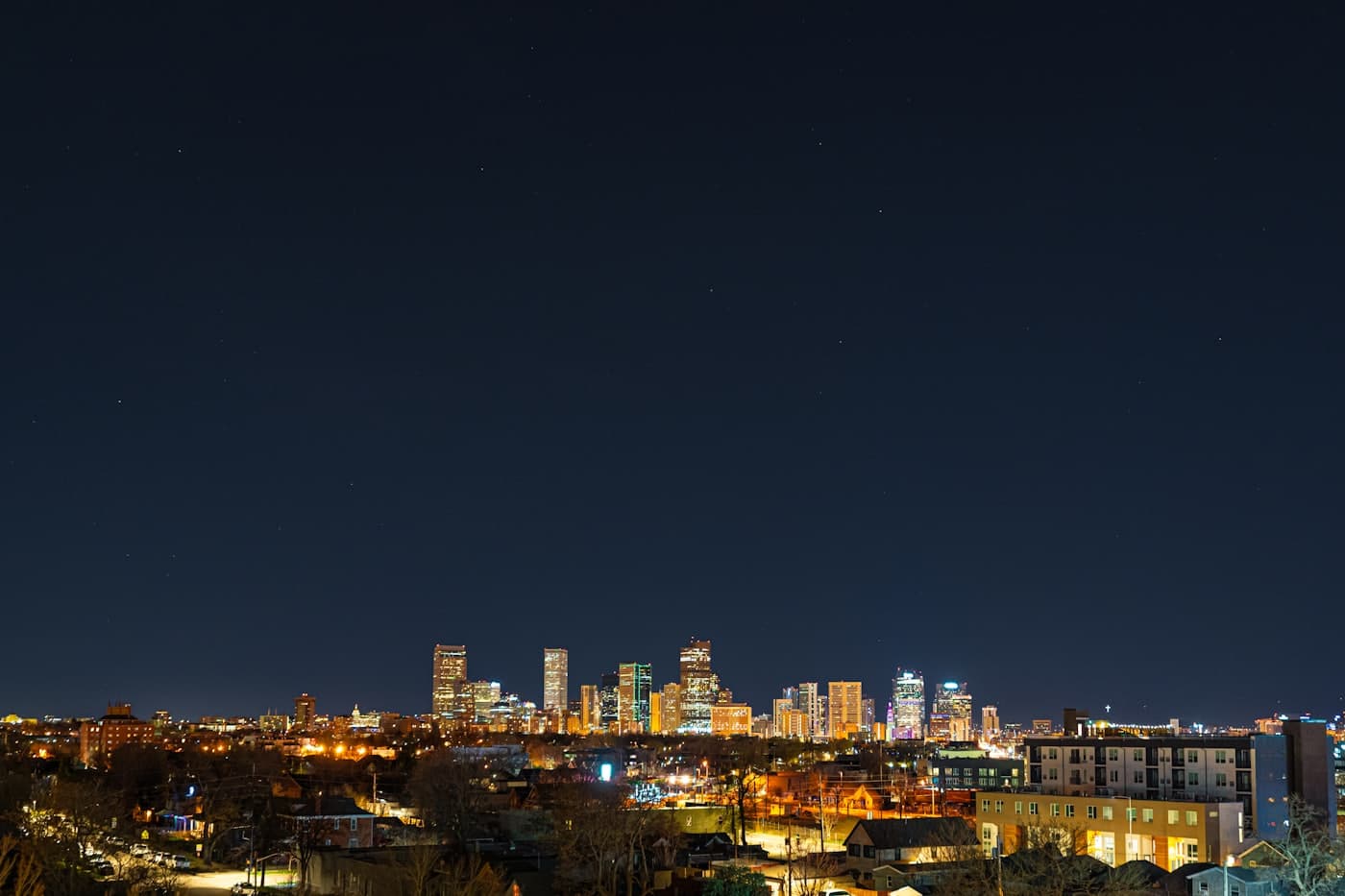 Downtown Denver with the Rocky Mountains behind the skyline